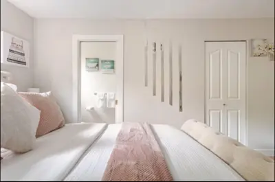 a white bedroom with a bed and a white door at The Oxford Signature Luxury Entire Family Suite in Coquitlam