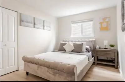 a bedroom with a large bed and a table at The Oxford Signature Luxury Entire Family Suite in Coquitlam