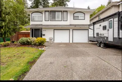 a rv parked in front of a house at The Oxford Signature Luxury Entire Family Suite in Coquitlam