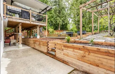 a house with a retaining wall and a patio at The Oxford Signature Luxury Entire Family Suite in Coquitlam