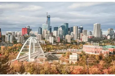 a city skyline with a white bridge in the foreground at The WEM House in Edmonton