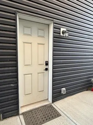 a white door on the side of a house at Arriva Homestay in Calgary