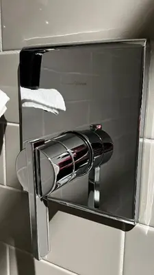 a chrome towel dispenser on a bathroom wall at ALL NEW 2BR Loft in Chilliwack