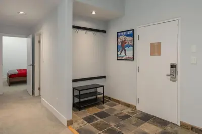 a hallway with a door and a sign on the wall at Tantalus Penthouse Mountain and Village Views in Whistler