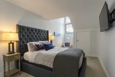 a bedroom with a large bed with a large headboard at Black Tusk - Top Floor, Best Location, Mtn Views in Whistler