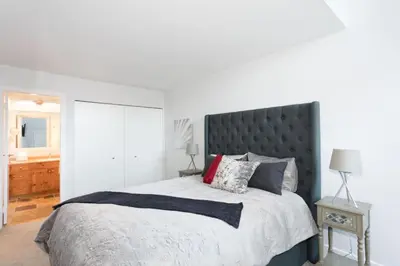a bedroom with a large bed with a black headboard at Black Tusk - Top Floor, Best Location, Mtn Views in Whistler