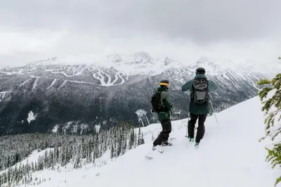 two people standing on top of a snow covered mountain at Black Tusk - Top Floor, Best Location, Mtn Views in Whistler