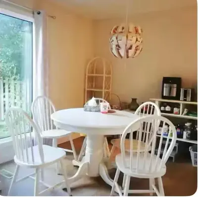 a white table and four white chairs in a room at greenview mck sunny room in Calgary