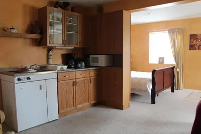 a kitchen with a sink and a bed in a room at Selah Retreat Guesthouse B&B in Sorrento