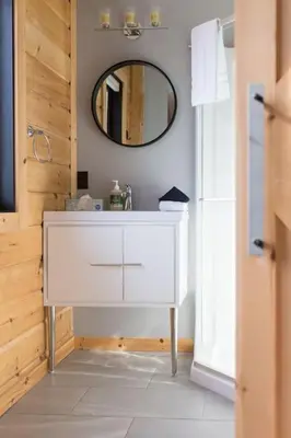 a bathroom with a white sink and a mirror at Snow Pines by StayIn in Fernie