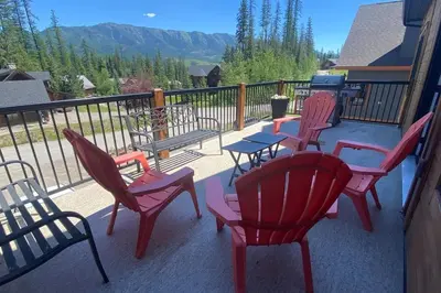 a group of chairs and tables on a balcony at Snow Pines by StayIn in Fernie