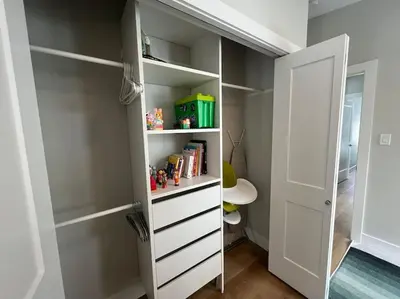 a room with a closet with white shelves at 4595 Alpine Way by StayIn in Fernie