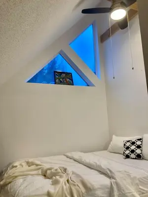 a bed in a room with a window at The BIRDs NEST in the Benchlands in Whistler