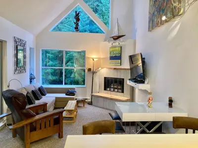 a living room with a couch and a fireplace at The BIRDs NEST in the Benchlands in Whistler