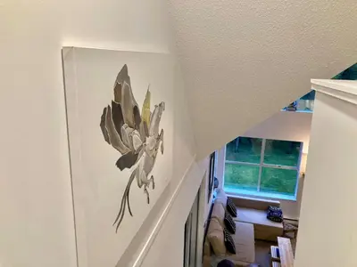 a painting of a flower on a wall in a hallway at The BIRDs NEST in the Benchlands in Whistler
