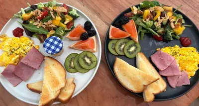 two plates with different types of breakfast foods on them at Hikari-Okanagan Sunshine B&B in Kelowna