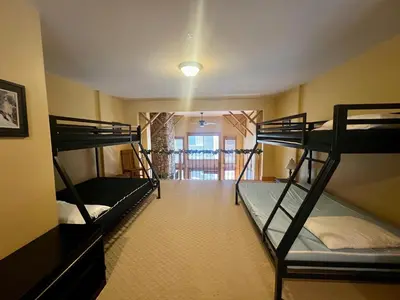 a room with three bunk beds and a hallway at Townhouse, Ski in Ski out in Big White