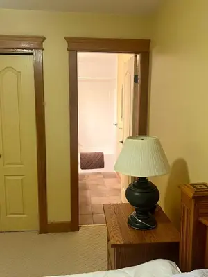 a lamp sitting on a table in a bedroom at Townhouse, Ski in Ski out in Big White