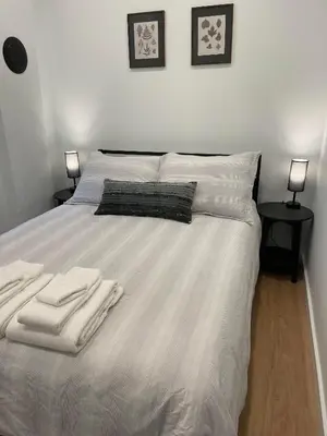 a bedroom with a bed with two towels on it at The Crow's Nest at the 1896 Building in Kaslo