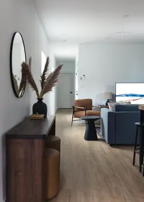 a living room with a couch and a mirror at The Crow's Nest at the 1896 Building in Kaslo