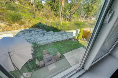 a window with a view of a patio with an umbrella at Elegant Home In Victoria,BC in Langford
