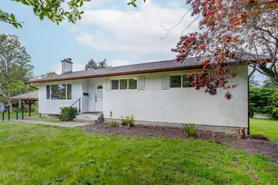 a white house with a grass yard at Stunning House In Victoria, BC in Victoria