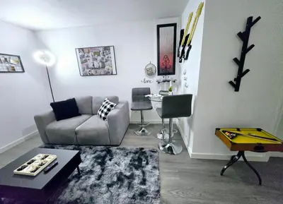 a living room with a couch and a table at Private Cozy 1Br Basement Suite Perfect for Couple! With Date Bar for 2! Self Check-in, Private Parking in Burnaby