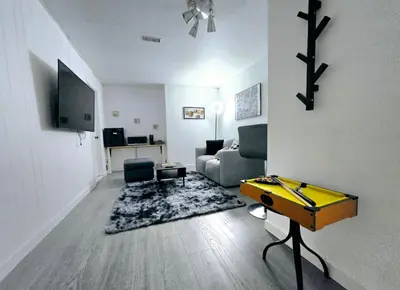 a living room with a couch and a table at Private Cozy 1Br Basement Suite Perfect for Couple! With Date Bar for 2! Self Check-in, Private Parking in Burnaby
