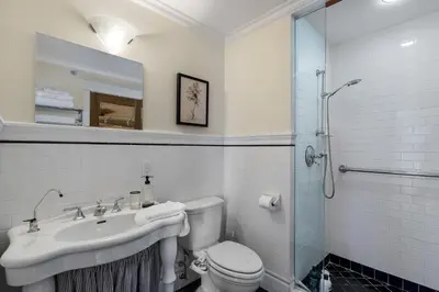 a bathroom with a sink and a toilet and a shower at The Vancouver Heritage Home - Mount Pleasant in Vancouver
