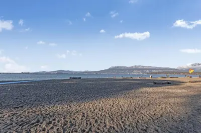 a sandy beach with the ocean in the background at Adorable 1-Bedroom Apartment on Kitsilano Beach in Vancouver