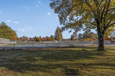 a tennis court with a tree in a park at Adorable 1-Bedroom Apartment on Kitsilano Beach in Vancouver