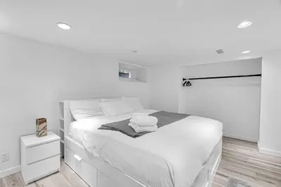 a white bedroom with a bed with towels on it at Comfortable 2-Bed Suite Near UBC in Vancouver