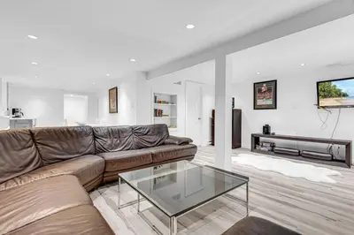 a living room with a couch and a glass table at Comfortable 2-Bed Suite Near UBC in Vancouver