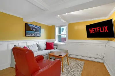 a living room with a couch and a tv at Artsy Private Guest Suite with Outdoor Saloon in Vancouver