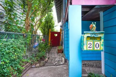 a blue house with a sign on the side of it at Artsy Private Guest Suite with Outdoor Saloon in Vancouver