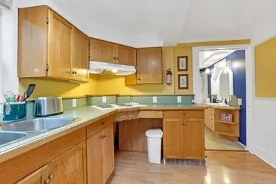 a kitchen with wooden cabinets and a sink at Artsy Private Guest Suite with Outdoor Saloon in Vancouver