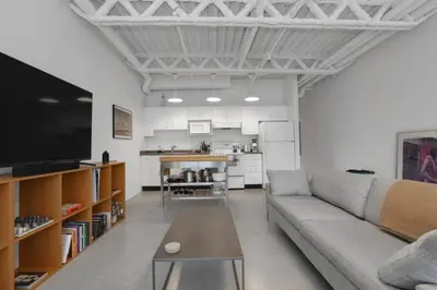 a living room with a couch and a table at Modern and Specious Condo right off Main St in Vancouver