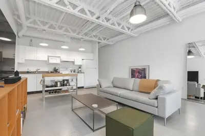 a living room with a couch and a table at Modern and Specious Condo right off Main St in Vancouver