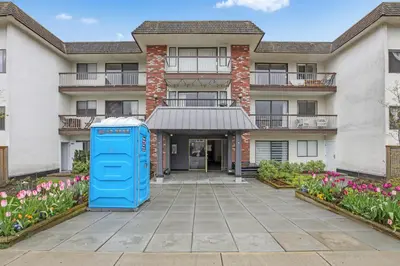 an old blue phone booth in front of a building at Modern Kitsilano 1 bedroom steps from the Beach in Vancouver