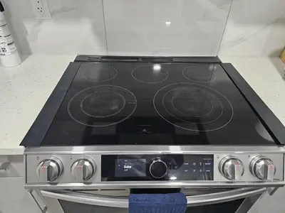 a stove top oven in a kitchen at Contemporary Two Bedroom Basement Suite in Edmonton