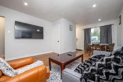 a living room with a couch and a table at Highland Park Upper Suite in Calgary