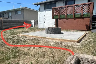 a yard with a deck with a red hose at Highland Park Upper Suite in Calgary