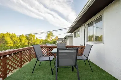 two chairs and a table on a balcony at Highland Park Upper Suite in Calgary