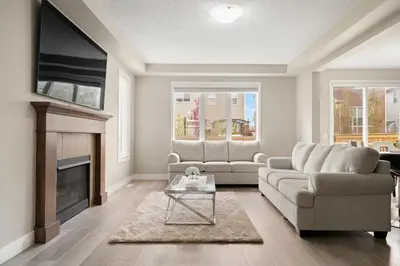 a living room with a couch and a fireplace at A beautiful home in Airdrie in Airdrie