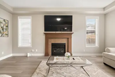 a living room with a fireplace and a tv at A beautiful home in Airdrie in Airdrie