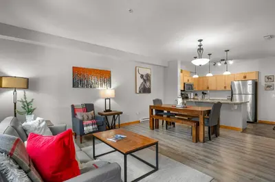 a living room with a couch and a table at Modern Cabin Vibes with pool at The Lodges in Canmore
