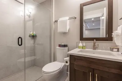 a bathroom with a toilet and a sink and a shower at New 1Bd Luxe King Suite with Superb Mtn View in Canmore