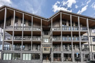 an exterior view of a building with balconies at New 1Bd Luxe King Suite with Superb Mtn View in Canmore