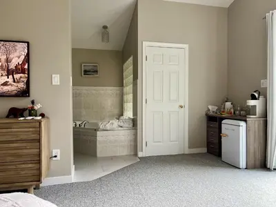 a bathroom with a bath tub and a sink at Five Gables B&B in Qualicum Beach