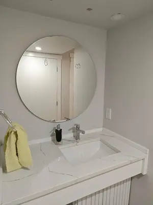 a bathroom with a white sink and a mirror at Chamber Inn in Edmonton